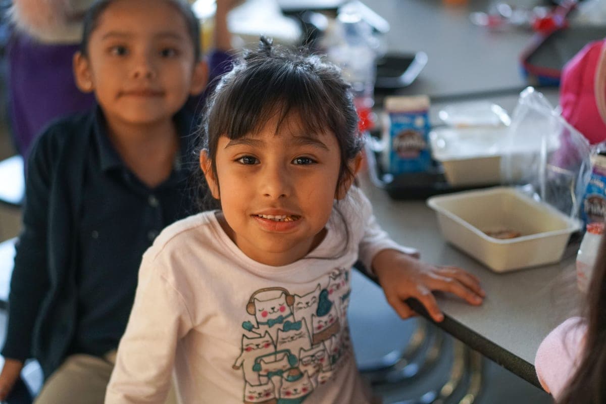 Student smiling while enjoying a Clark Foods Co. meal