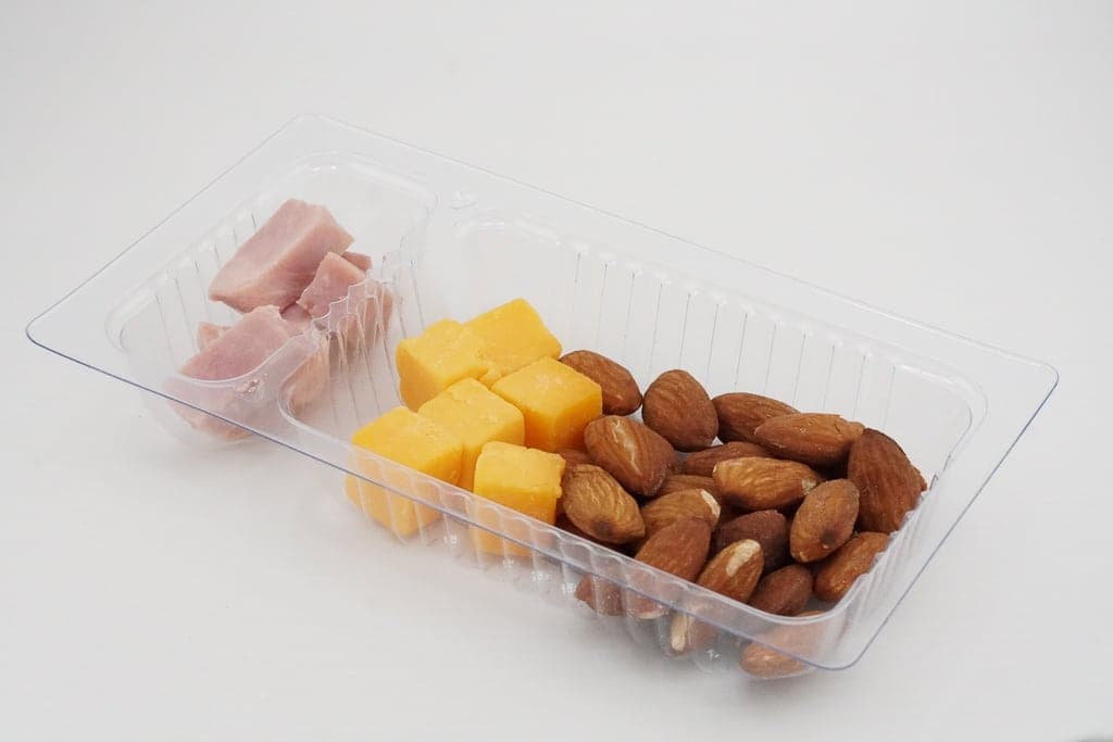 Hot entree portioned in a clear sealed container ready for service